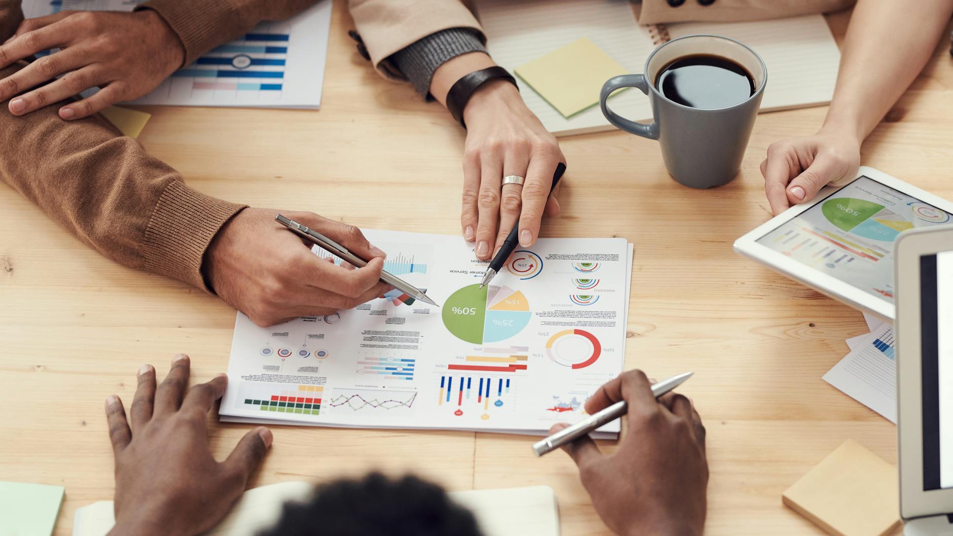 Workers at a table looking at a chart.