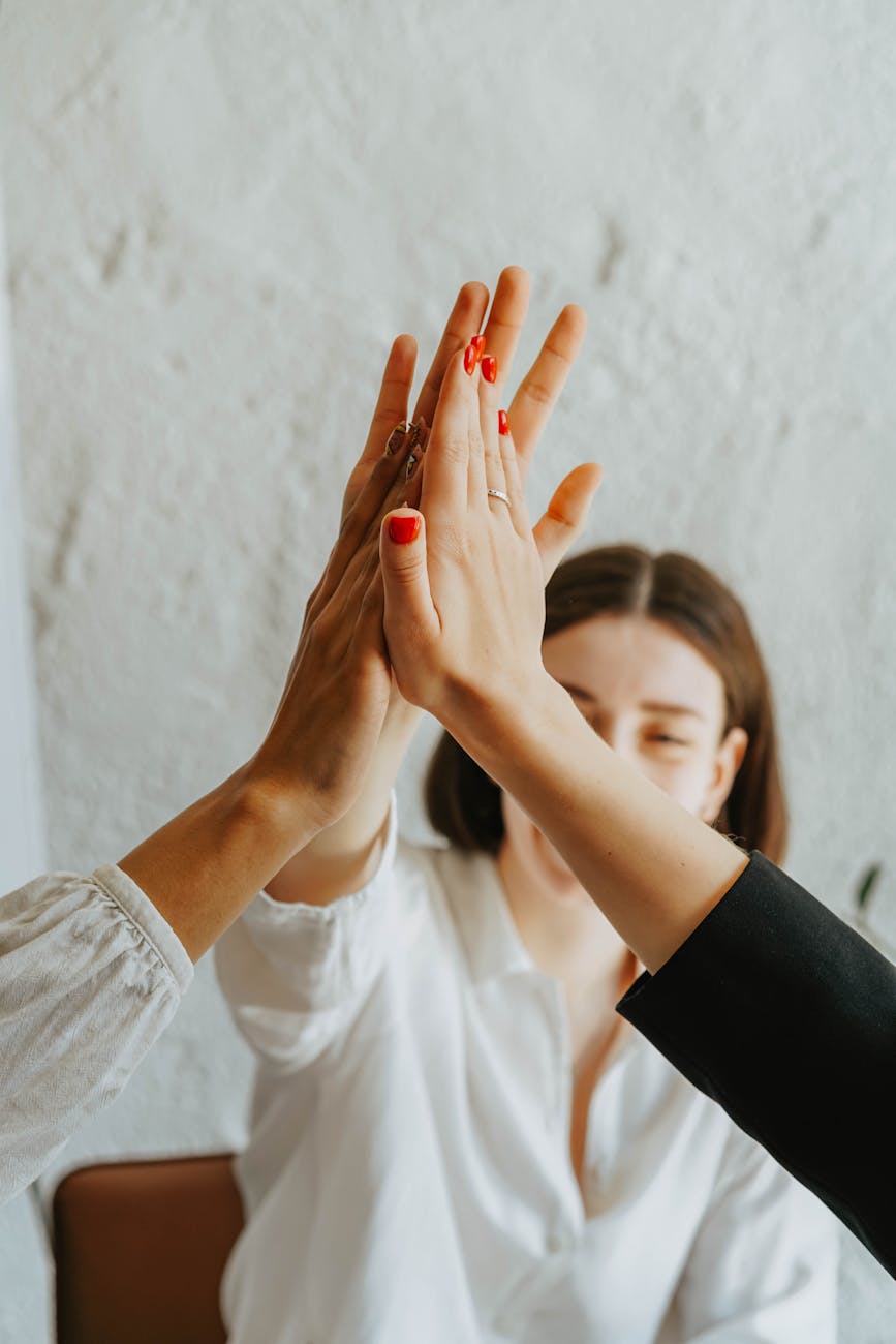 Three women doing a high five.