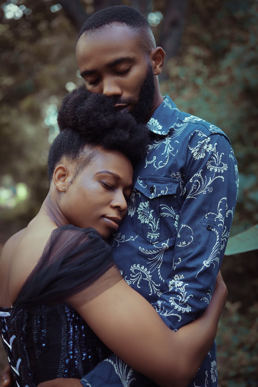Black couple in love hugging each other.