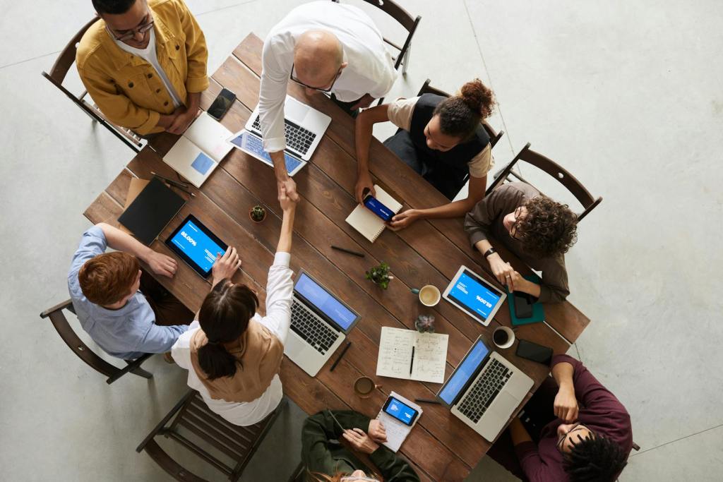 Big group of people sitting at a table for a meeting.